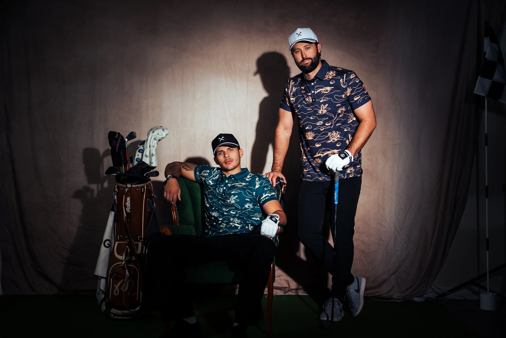 Two golfers in Byrd Gang patterned polos